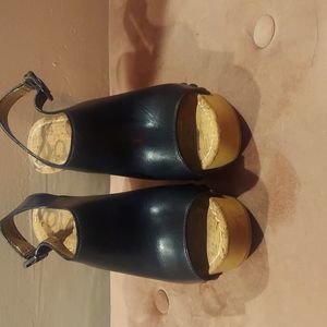 I am selling  a size 7/12 black and brown wedge sandal.
